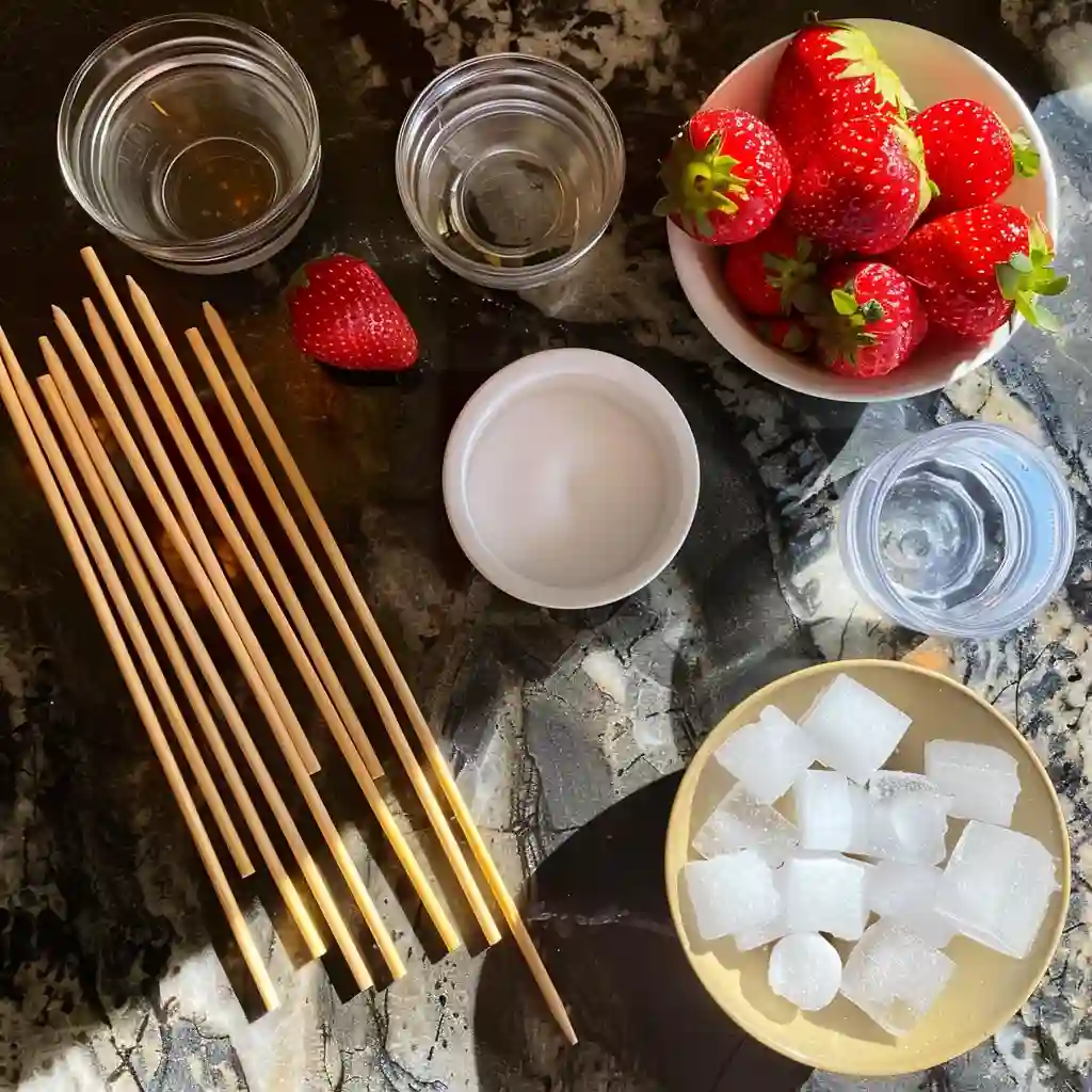 Tanghulu Challenge ingredients including strawberries, sugar, and candy tools