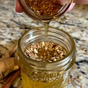 Pouring herbal tea over seeds in a mason jar