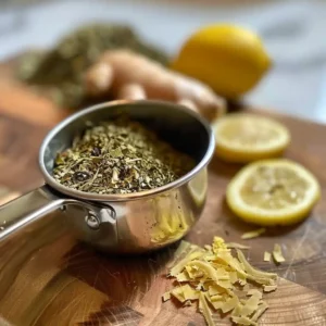 Lemon balm tea served with lemon slice and mint on a wooden tray