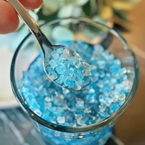 Warm filtered water being poured into a glass with blue salt nearby