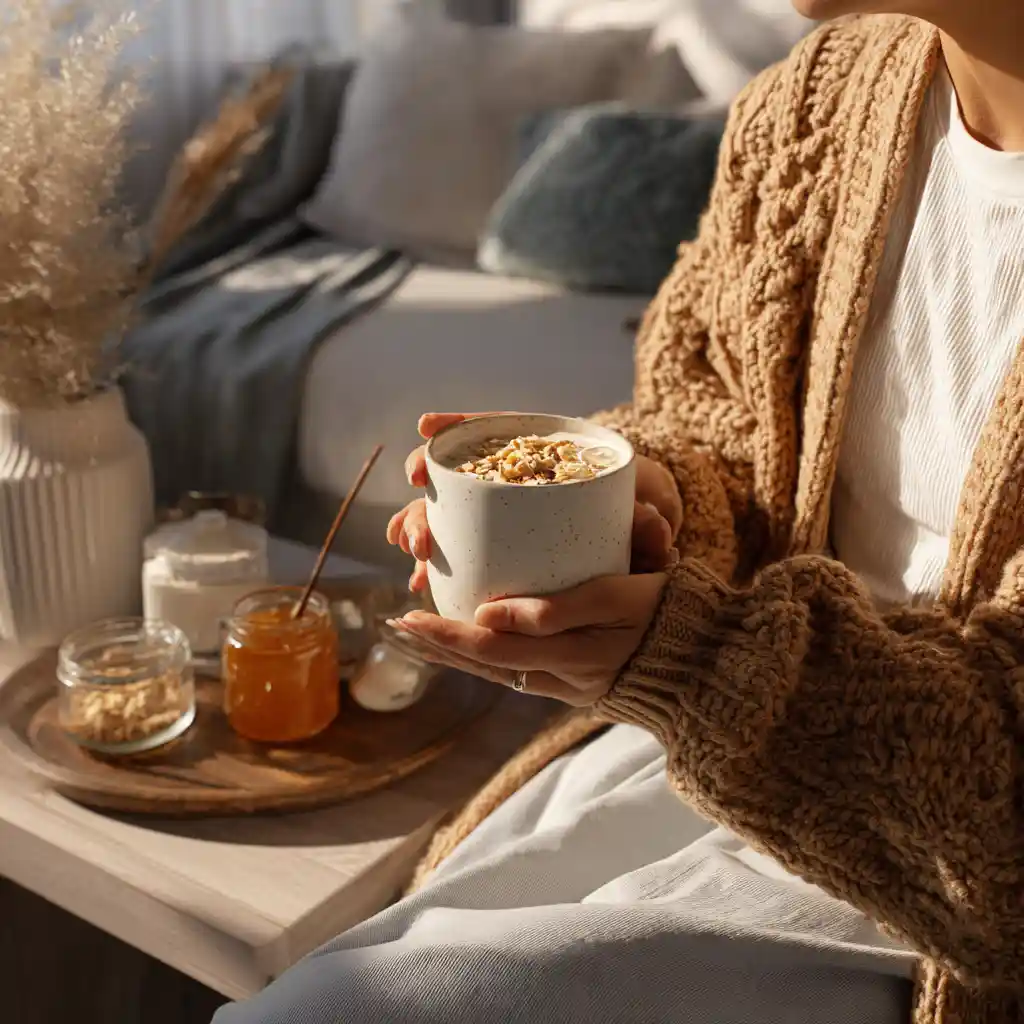 Cozy living room scene with someone holding a weight loss smoothie